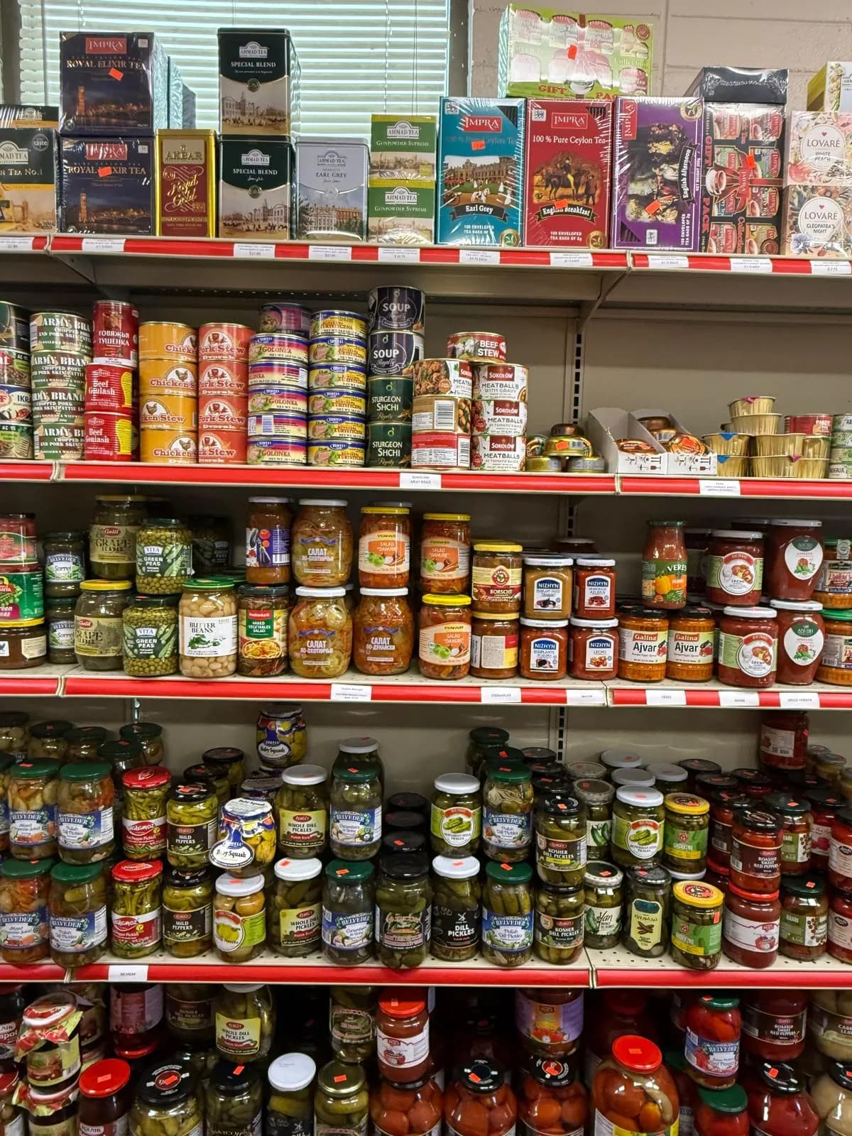 A wall of jarred pickles, vegetables, and fruit preserves